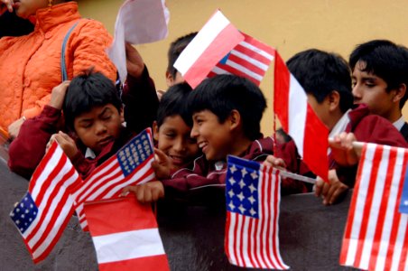 US Navy 070807-N-0194K-098 Children attending Sanchez Carrion School in Salaverry, Peru, wave Peruvian and handmade U.S. flags during an opening ceremony