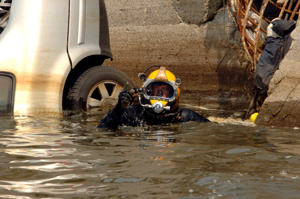 US Navy 070808-N-3093M-011 Navy Diver 1st Class Josuha Harsh of Mobile Diving and Salvage Unit (MDSU) 2 from Naval Amphibious Base Little Creek, Va., surfaces after completing a salvage dive