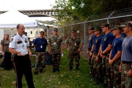 US Navy 070808-N-3093M-019 Hennepin County Sheriff Richard Stanek congratulates the new chief selects and thanks the Sailors of Mobile Diving and Salvage Unit (MDSU) 2 for their efforts in aiding with the disaster relief