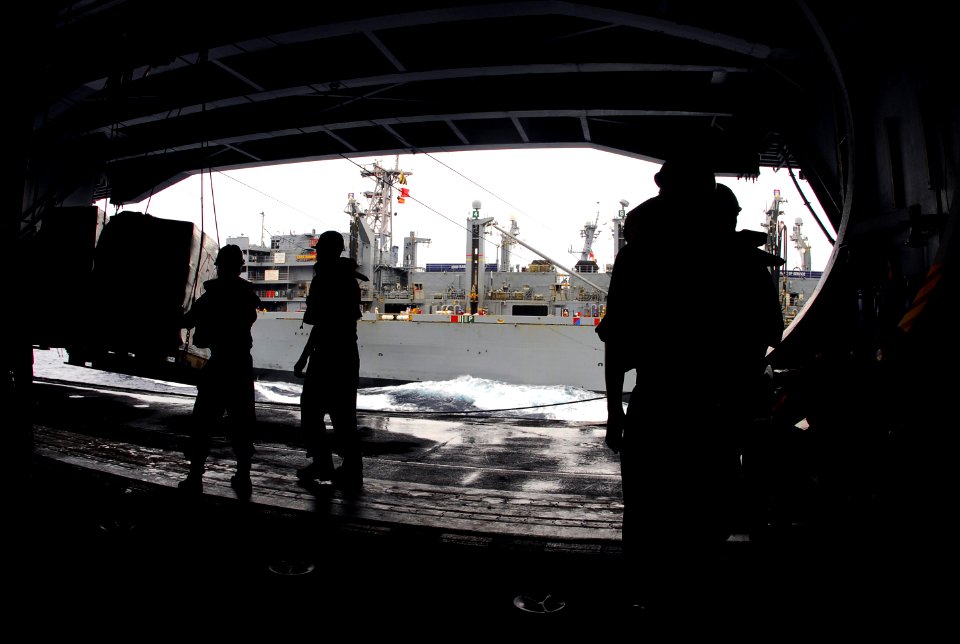 US Navy 070804-N-9760Z-016 Sailors aboard the nuclear-powered aircraft carrier USS Nimitz (CVN 68) release chains from cargo while conducting a replenishment at sea with the Military Sealift Command fast combat support ship USN