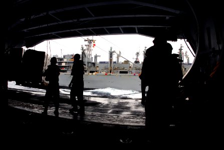 US Navy 070804-N-9760Z-016 Sailors aboard the nuclear-powered aircraft carrier USS Nimitz (CVN 68) release chains from cargo while conducting a replenishment at sea with the Military Sealift Command fast combat support ship USN