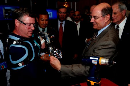 US Navy 070807-N-3642E-403 Secretary of the Navy (SECNAV) the Honorable Dr. Donald C. Winter, gives his official SECNAV coin to Chuck Hilderth during the Defense Advanced Research Projects Agency (DARPA) Tech conference