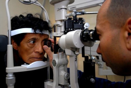 US Navy 070806-N-6081J-007 Cmdr. Octavio Borges, an ophthalmologist aboard the Military Sealift Command (MSC) hospital ship USNS Comfort (T-AH 20), examines a Peruvian patient photo
