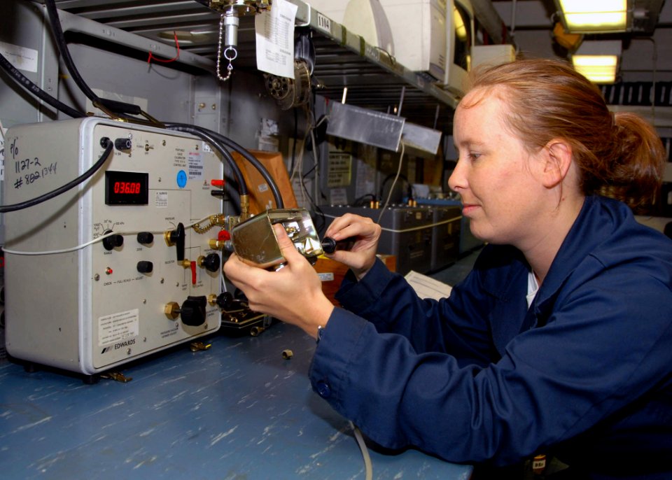 US Navy 070807-N-9898L-015 Aviation Electronics Technician Airman Micky Stump calibrates a piece of equipment in the Calibration Lab aboard the Nimitz-Class aircraft carrier USS Abraham Lincoln (CVN 72)