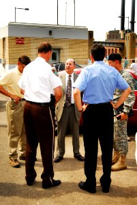 US Navy 070808-N-4515N-136 Secretary of the Navy (SECNAV) the Honorable Donald C. Winter, center, meets with Department of Defense, federal, state, and local officials at the scene of the I-35 bridge collapse