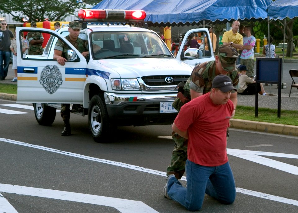 US Navy 070807-N-0483B-007 Members of Commander Fleet Activities Yokosuka (CFAY) Security apprehend a suspect as part of a security demonstration held at 24th Annual National Night Out onboard CFAY