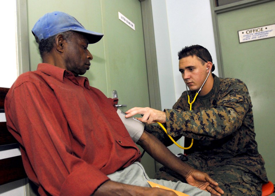 US Navy 070808-N-4954I-016 Hospital Corpsman 3rd Class Michael Parke checks the blood pressure of a local Madang resident at Modilon General Hospital in support of Pacific Partnership