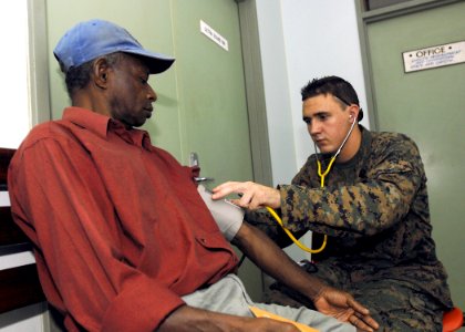 US Navy 070808-N-4954I-016 Hospital Corpsman 3rd Class Michael Parke checks the blood pressure of a local Madang resident at Modilon General Hospital in support of Pacific Partnership