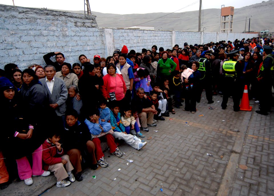 US Navy 070808-N-6278K-041 Patients wait outside the Miguel Grau School, for medical care provided by medical staff attached to the Military Sealift Command (MSC) hospital ship USNS Comfort (T-AH 20)
