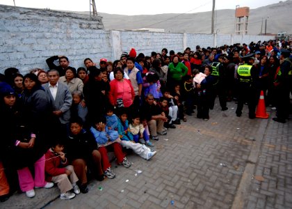 US Navy 070808-N-6278K-041 Patients wait outside the Miguel Grau School, for medical care provided by medical staff attached to the Military Sealift Command (MSC) hospital ship USNS Comfort (T-AH 20) photo