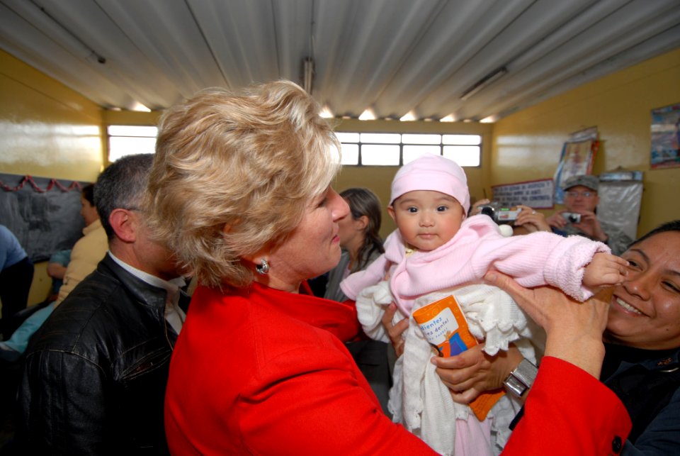 US Navy 070808-N-8704K-371 Under Secretary for Diplomacy and Public Affairs Karen Hughes is greeted by young child and her mother at the Miguel Grau School