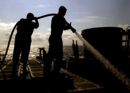 US Navy 070807-N-8132M-031 Hull Technician 2nd Class Albert Pastoor and Gunners Mate 2nd Class Christopher Rozecki assist with a fresh water wash down