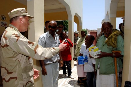 US Navy 070808-N-3931M-040 Rear Adm. James Hart, commander, Combined Joint Task Force-Horn of Africa, talks with local residents at the Assamo Medical Clinic photo