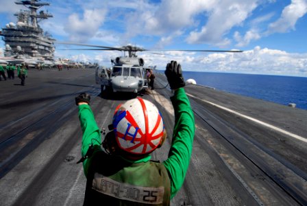 US Navy 070809-N-6326B-043 Aviation Structural Mechanic Airman Joshua Dowdy prepares an SH-60F Seahawk helicopter, assigned to the Indians of Helicopter Anti-Submarine Squadron (HS) 6, for take off on the flight deck