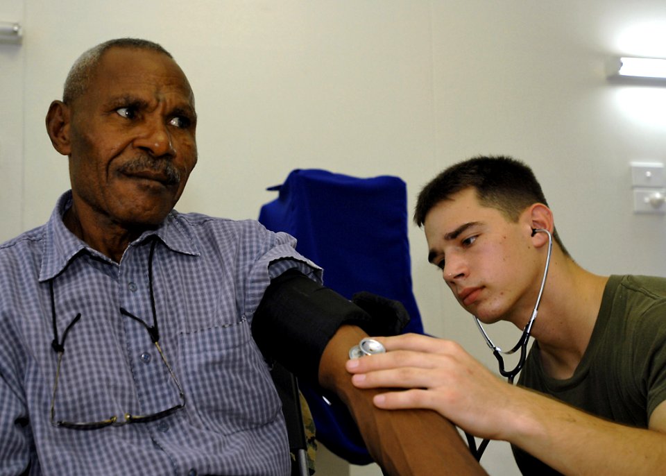 US Navy 070808-N-4954I-041 Hospital Corpsman 3rd Class Phil Garber checks the blood pressure of a local resident at Modilon General Hospital in support of Pacific Partnership