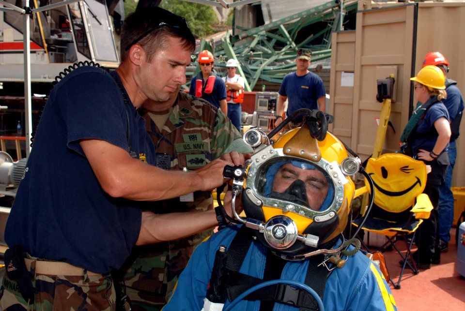 US Navy 070808-N-3093M-020 Chief Navy Diver Scott Maynard of Mobile Diving and Salvage Unit (MDSU) 2 makes final checks on Navy Diver 2nd Class Noah Gotteman's MK-21 diving helmet