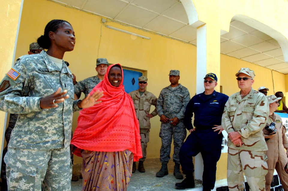 US Navy 070808-N-3931M-096 U.S. Army 1st Lt. Cassandra McGinnis explains the mission and accomplishments of the 1132nd Well Drillers at the Assamo well drilling site