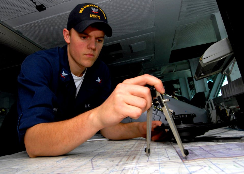US Navy 070808-N-9898L-026 Quartermaster 3rd Class Michael Brown plots a course as a watch stander on the bridge of Nimitz-class aircraft carrier USS Abraham Lincoln (CVN 72)