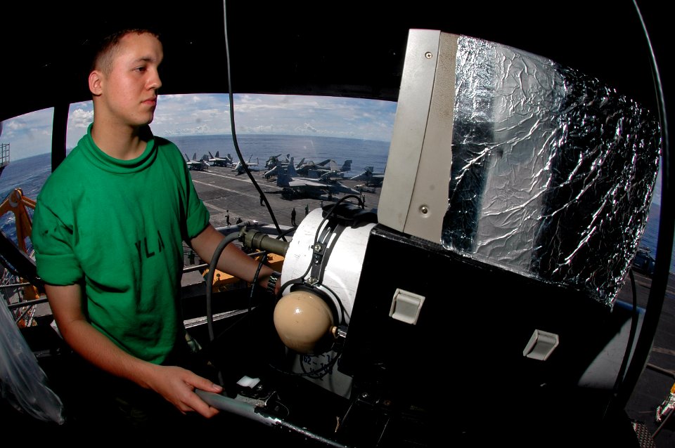 US Navy 070810-N-7883G-011 Interior Communications Electrician 3rd Class Jose Hernandez tests the plat camera in USS Kitty Hawk (CV 63) island camera booth