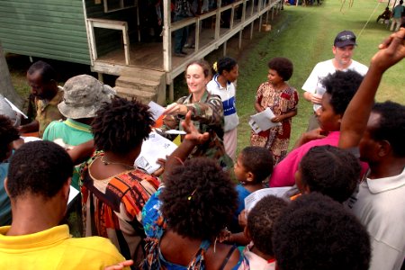 US Navy 070808-N-9421C-143 Lt. Lydia Battey distributes handouts explaining the symptoms of tuberculosis to local residents at Bunabun Health Center in Madang, Papua New Guinea photo