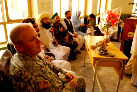 US Navy 070811-N-3385W-789 Cmdr. David Adams, commanding officer of Provincial Reconstruction Team Khost, looks on as the new chancellor of Khost University is installed