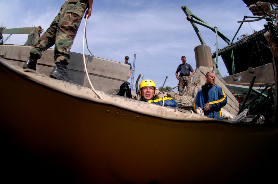 US Navy 070808-N-3093M-017 Members of Mobile Diving and Salvage Unit (MDSU) 2 from Naval Amphibious Base Little Creek, Va., swim through debris searching for victims of the I-35 bridge collapse