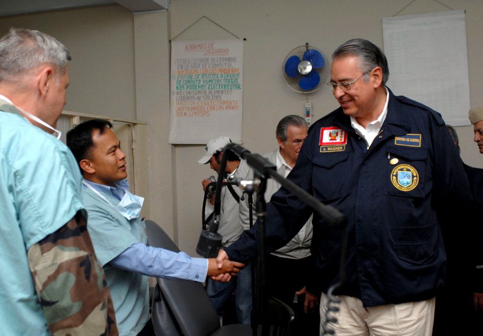 US Navy 070809-N-7088A-241 Minister of Defense for Peru, Allen W. Tizon, greets Hospital Corpsman 2nd Class Antonio Tingco, while on a tour of the Jose F. Sanchez Carrion School
