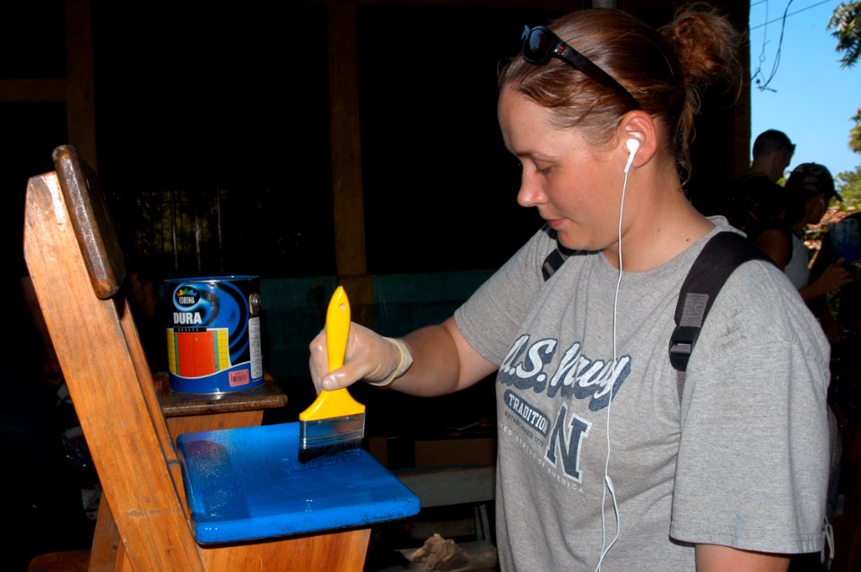 US Navy 070808-N-7029R-032 Seaman Johnson helps painting chairs during a community relations project held at the Profesor Domingo Flores Mejilla School, in support of Partnership of the Americas (POA) 2007