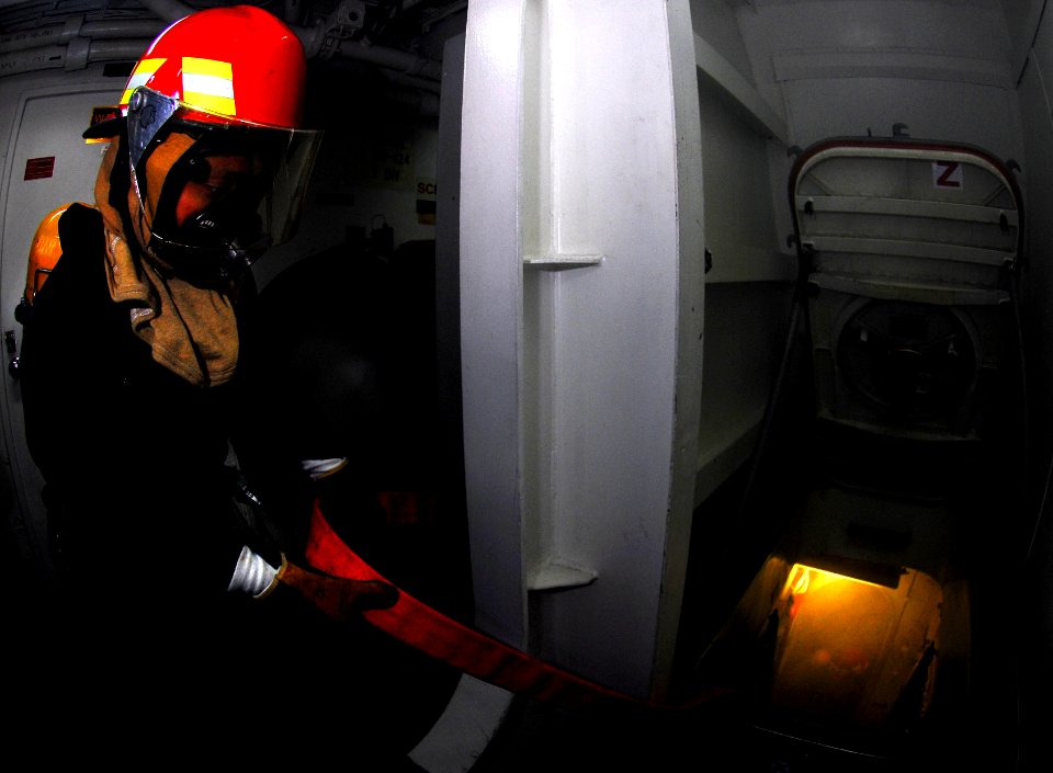 US Navy 070810-N-0684R-025 DCFN Lori Morgan attempts to look through the smoke of a simulated fire during a fire drill