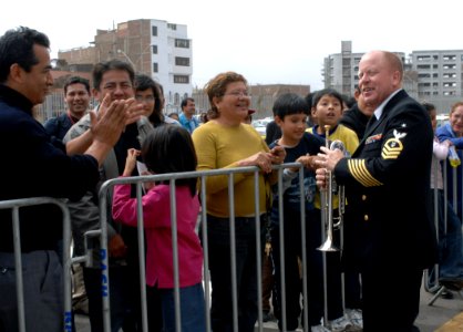 US Navy 070811-N-7088A-249 Senior Chief Musician David Wiley, conductor and performer for the U.S. Navy Showband attached to the Military Sealift Command (MSC) hospital ship USNS Comfort (T-AH 20), speaks with a crowd following photo