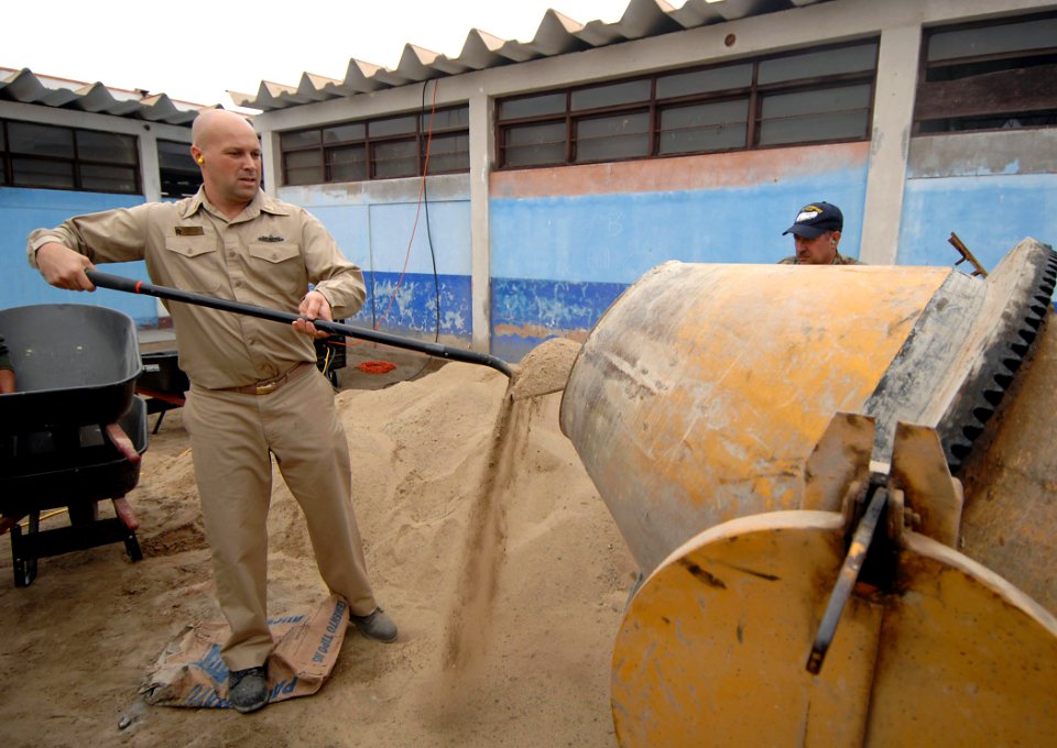 US Navy 070810-N-0194K-297 Senior Chief Operations Specialist Gene DeMers, attached to hospital ship USNS Comfort (T-AH 20), mixes concrete at Miguel Grau School in Salaverry