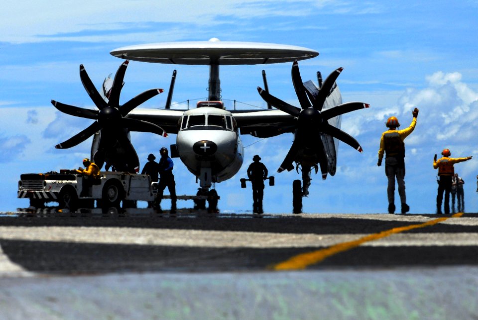 US Navy 070813-N-2659P-098 Flight deck personnel assist with the taxing of an E-2C Hawkeye attached to the