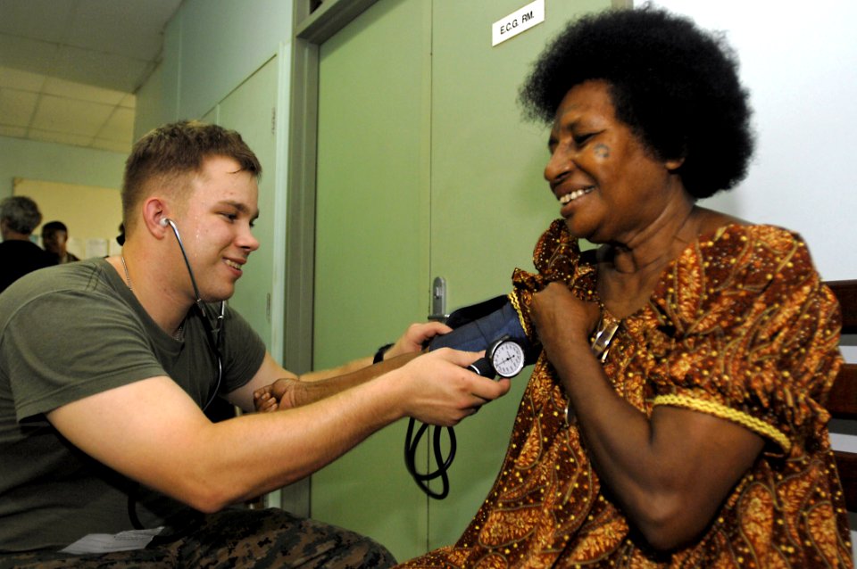 US Navy 070808-N-4954I-021 Hospitalman Brian Robinson removes a blood pressure cuff from a local resident at Modilon General Hospital in support of Pacific Partnership