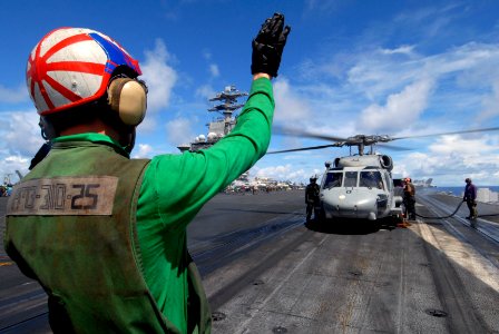 US Navy 070809-N-6326B-033 Aviation Structural Mechanic Airman Joshua Dowdy prepares an SH-60F Seahawk helicopter, assigned to the Indians of Helicopter Anti-Submarine Squadron (HS) 6, for take off
