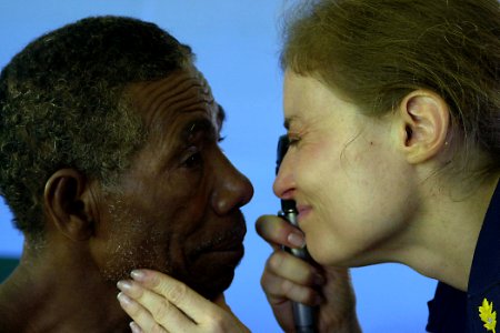 US Navy 070809-N-9195K-015 Cmdr. Elizabeth Satter performs an eye exam on a local man during a medical civic action program (MEDCAP) at Bunabun Heath Center in support of Pacific Partnership
