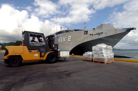 US Navy 070809-N-0989H-039 Mineman 1st Class April Morehouse assigned to the High Speed Vessel (HSV) 2 Swift prepares to load medical supplies that were donated by Project Handclasp photo