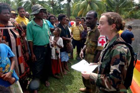 US Navy 070808-N-9421C-134 Lt. Lydia Battey discusses the symptoms of tuberculosis to local residents at Bunabun Health Center photo