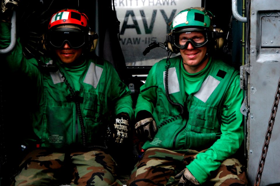 US Navy 070811-N-7883G-014 Two Sailors attached to the Warlords of Helicopter Anti-Submarine Squadron Light (HSL) 51, sit in a SH-60B Seahawk helicopter during flight operations aboard the USS Kitty Hawk (CV 63)