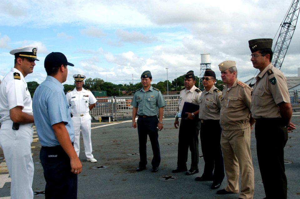 US Navy 070814-N-7029R-015 Operations Specialist Seaman Hector Gonzales translates while Lt. Cmdr. Daniel Caldwell, USS Pearl Harbor (LSD 52) executive officer explains the ship's mission during a tour