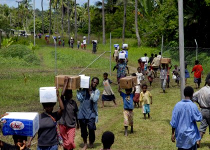 US Navy 070811-N-4267W-072 osephstaal villagers help carry supplies from a landing zone to a remote project site where Seabees assigned to Naval Mobile Construction Battalion (NMCB) 7, Amphibious Construction Battalion (ACB) 1