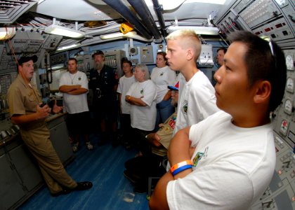 US Navy 070809-N-9758L-021 Auxiliary officer, Lt. j.g. Scott Martin, assigned to the guided-missile frigate USS Reuben James (FFG 57), explains the controls and operation of the central control station to Boy Scouts and Troop L