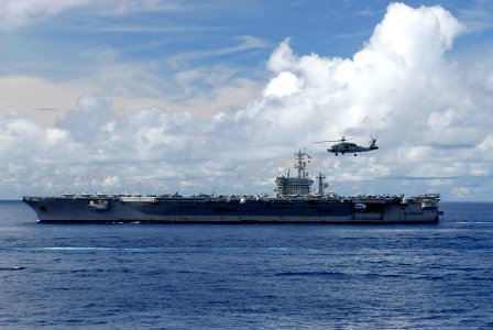 US Navy 070814-N-8157C-152 An HH-60H Seahawk helicopter flies past the Nimitz-class aircraft carrier USS Nimitz (CVN 68) during a joint photo exercise (PHOTOEX) concluding Valiant Shield 2007