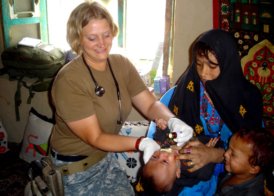US Navy 070815-N-0000X-001 Hospital Corpsman 1st Class Jennifer Kraus de-worms an infant Afghan boy
