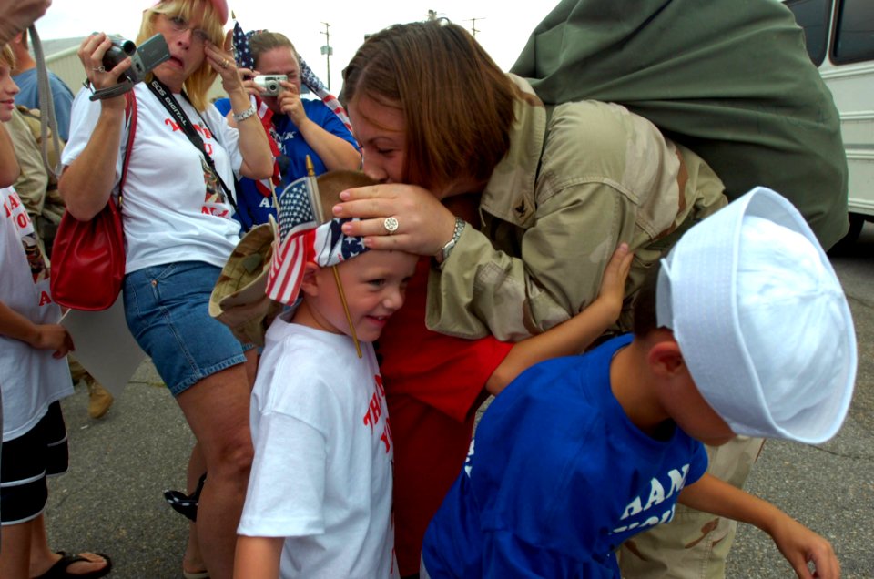 US Navy 070811-N-6676S-169 An Individual Augmentee (IA) attached to Navy Provisional Detainee Battalion (NPDB) 2, kisses the top of her son's head as she is welcomed to Naval Station Norfolk, Va., by friends and family