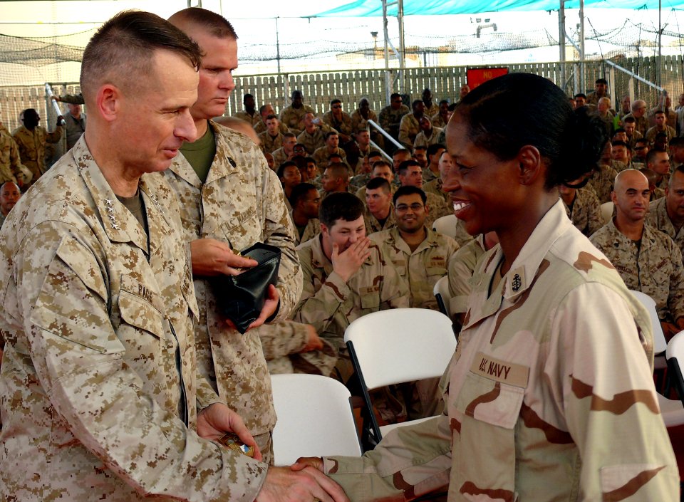 US Navy 070814-F-1779B-219 Chairman of the Joint Chiefs of Staff Gen. Peter Pace gives a challenge coin an U.S. Navy chief petty officer during his Town Hall Meeting at Camp Lemonier