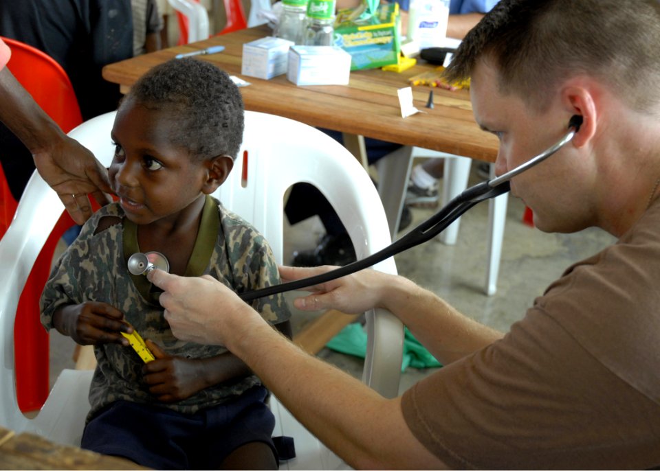 US Navy 070810-N-4267W-016 Lt. David King from Naval Medical Center San Diego, examines a child during a medical civil-assistance program (MEDCAP) at Josephstaal Medical Clinic