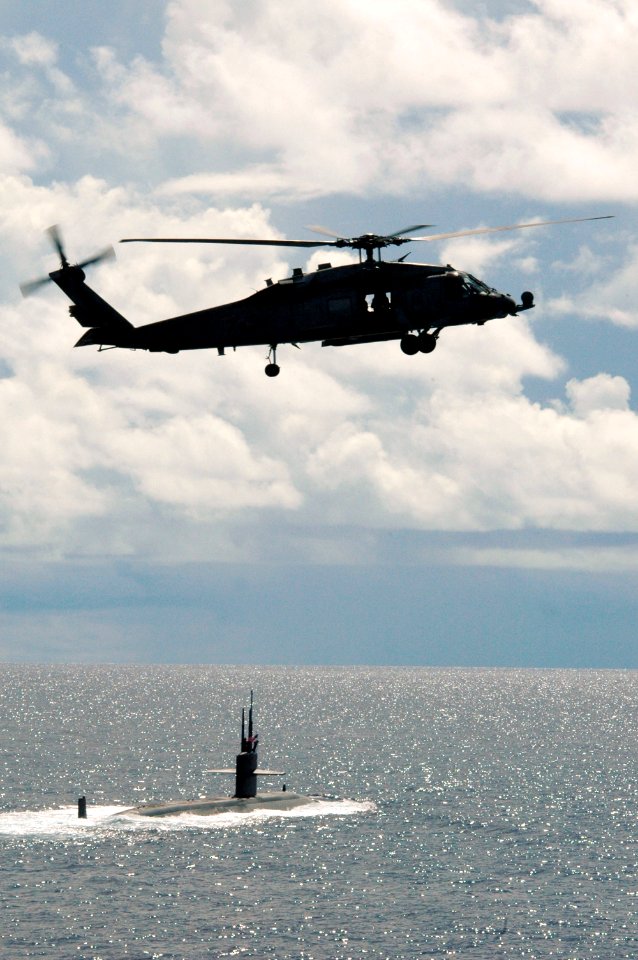 US Navy 070814-N-3136P-041 An HH-60H Seahawk from Helicopter Anti-Submarine Squadron (HS) 14 assigned to USS Kitty Hawk (CV 63) flies over USS Key West (SSN 722) prior to Valiant Shield's photo exercise