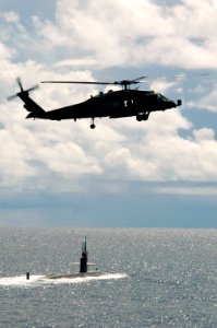 US Navy 070814-N-3136P-041 An HH-60H Seahawk from Helicopter Anti-Submarine Squadron (HS) 14 assigned to USS Kitty Hawk (CV 63) flies over USS Key West (SSN 722) prior to Valiant Shield's photo exercise