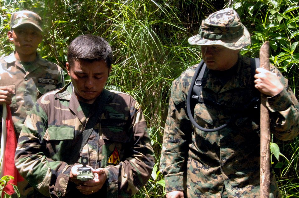 US Navy 070813-N-0989H-186 Cpl. Oscar Garcia, assigned to a U.S. Marine Corps mobile training team, assists a Guatemalan marine with compass reading during a land navigation exercise as part of the U.S. Marine Corps Small Unit