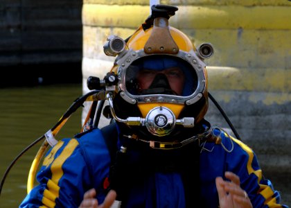 US Navy 070811-N-3093M-017 Chief Navy Diver Scott Maynard attached to Mobile Diving and Salvage Unit (MDSU) 2, readies for a dive into the Mississippi river in support of ongoing search and recovery operations in Minneapolis